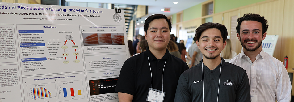 students standing at research poster