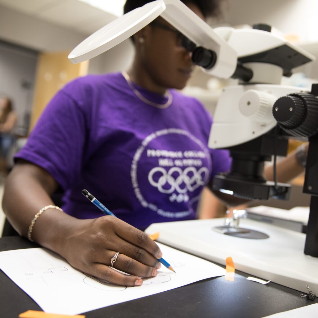 student at microscope